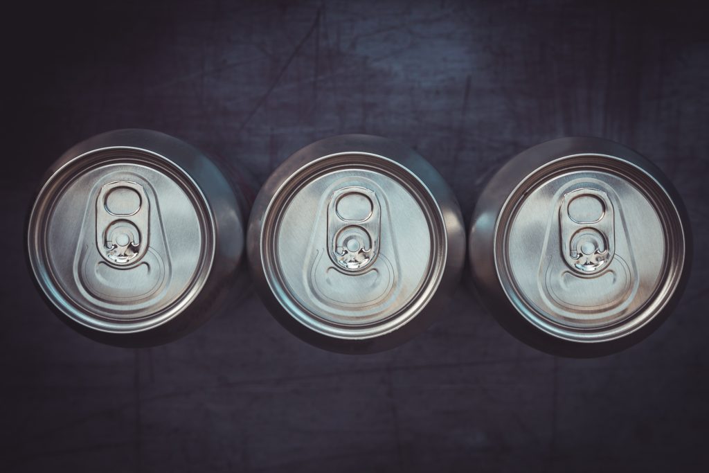 Three tops of soda cans
