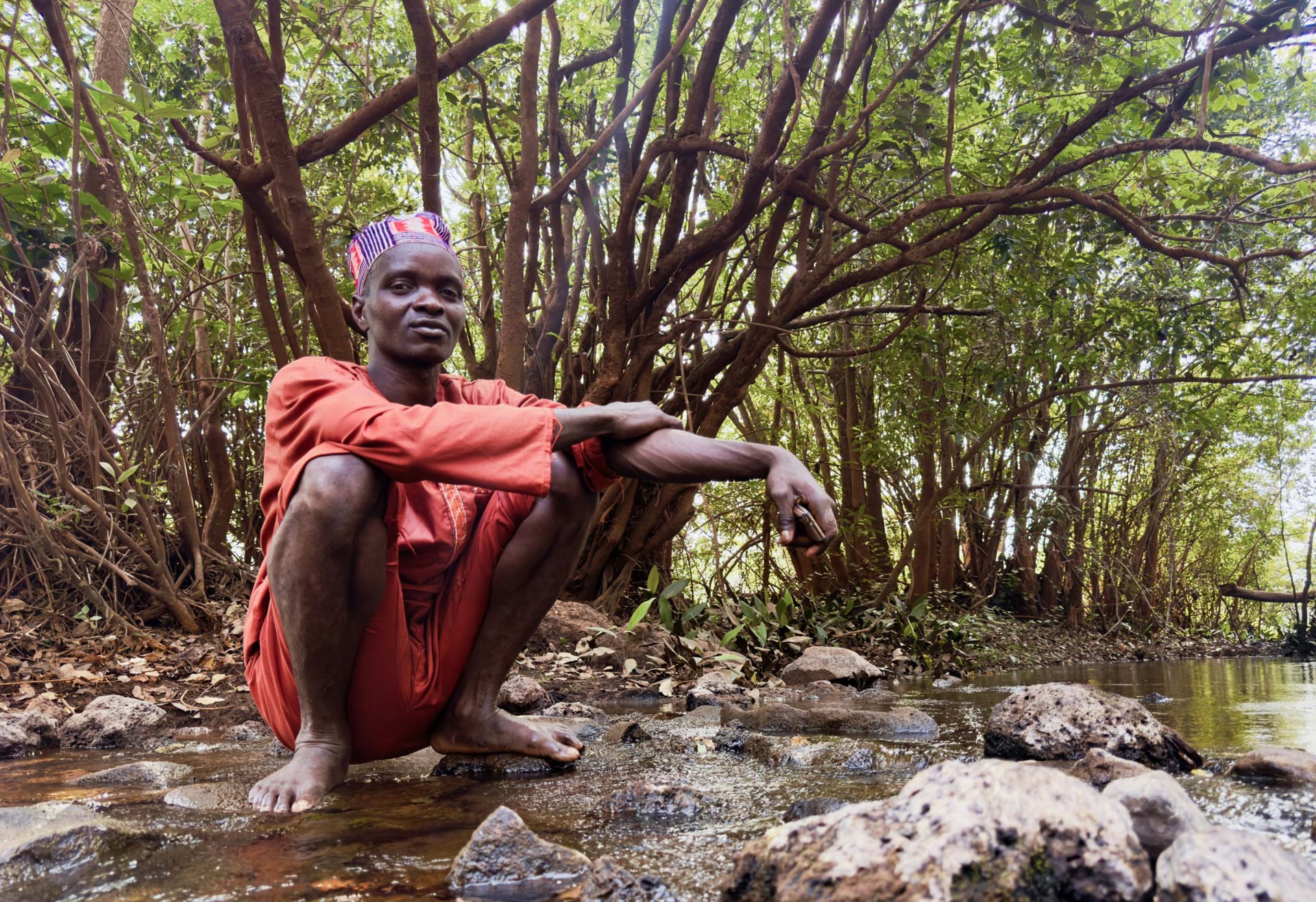 Boubacar Bah resting beside the Cogon River.